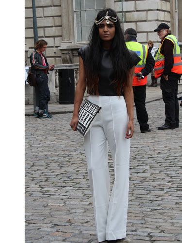 Big-time blogger Kavita from She Wears Fashion has been rocking some seriously fierce looks this fashion week. Never one to dress by the book, she mixes the exotic- that beaded headband- with the classic, in high-waisted palazzo pants and a leather tee. Our favourite touch, though, is that cheeky graphic clutch.