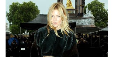 Sienna Miller rocked up with her tousled blonde locks caught slightly in the London GALE that took the city by (a literal) storm before the show kicked off, looking chic in a pencil skirt and cropped furry jacket.