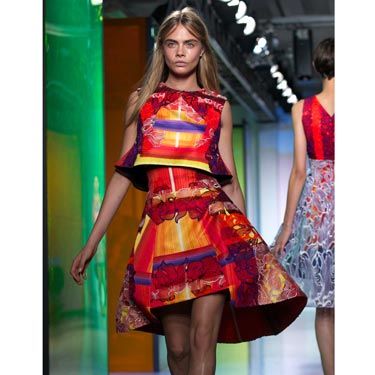 <p>From pastel greens to deep reds, Cara looked stunning in her second look at Peter Pilotto. The structured, printed top and skirt combo was a fierce outfit. </p>
