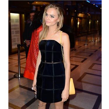 <p><a href="http://www.cosmopolitan.co.uk/fashion/news/cara-delevingne-london-fashion-week-style-so-far" target="_blank">Cara</a> was out and about last night in Milan sporting a more feminine look than we're used to seeing, wearing a midnight blue structured strapless mini-dress with red peeptoe heels. Her long hair was worn down and parted to the sign, giving her a softer feminine look. We love. </p>
