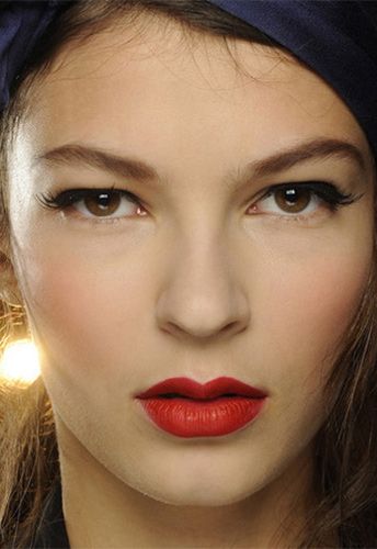 <p><strong>The makeup look:</strong> "A 1950s pin-up beauty…think Dita Von Teese, but in a naughty way, a pin-up that danced to much and is back from the party" said Makeup Artist Carole Colombani using MAC.</p>
<p><strong>The products:</strong> Face - Pinch Me Powder Blush blended over the centre of cheeks for a healthy flush. Eyes - Veluxe Brow Liner used to define the brows in a "retro" way: Perfected two-thirds of the way starting at the inner brow, then sketched in a broken line after the arch before being brushed upwards, lifting the brow. Blacktrack Fluidline drawn through the upper lashline starting at the extreme inner corner and extending outwards to lift and elongate eyes. False Lash Black Mascara blended through the upper lashes only to lengthen and define. 20 Lash half-demis applied above the outer corners of lashes to extend and lift eyes with a beautiful flick. Lips - MAC PRO Crimson and Red Lipmix mixed together for intensity. MAC PRO Basic Red Chromagraphic Pencil used to define, creating a slightly bigger and fuller lower lip to finish.</p>