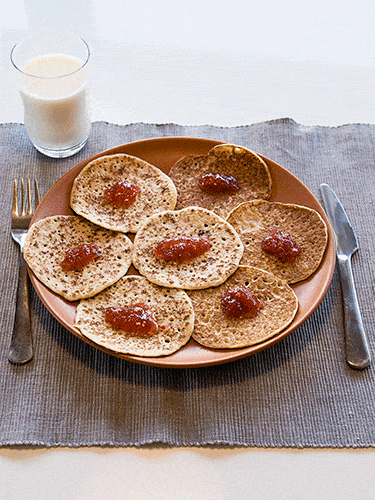 <p>This recipe uses wholemeal flour and banana instead of oil to keep the calorie count down to 219 per serving (this recipe makes four). That's a savings of around 250 calories compared to your typical pancake recipe! </p>
<p><strong>Ingredients</strong></p>
<p><em>For the pancakes</em></p>
<p>125g wholemeal flour </p>
<p>2tsp baking powder </p>
<p>1 egg, beaten </p>
<p>300ml skimmed milk</p>
<p>1 small banana well mashed</p>
<p><em>For the cherry compote</em></p>
<p>250g cherries, stoned</p>
<p>2tsp lemon juice</p>
<p>30g sugar</p>
<p>½tsp cinnamon</p>
<p><strong>Method:</strong></p>
<p>Combine the pancake ingredients in a bowl to make the batter. In a saucepan heat all the compote ingredients, simmering for 10 minutes until the cherries are softened and the sauce has become syrupy. If the sauce is too runny, turn up the heat and boil rapidly for a minute or two, then allow to cool slightly.</p>
<p>While the cherries are cooking, heat a heavy-based, non-stick frying pan, griddle or bake stone to a medium temperature. To make each pancake, pour in a tablespoon of the mixture and cook until you see bubbles rising and the top begins to dry. Then flip over and cook the other side for a further minute.</p>
<p>Cook 3 or 4 at a time depending on the size of the pan.</p>
<p>Once cooked, remove from the pan and keep warm in a folded teatowel while you cook the next batch. Continue until all of the mixture is used up. It should make about 20. Serve a pile of 4 or 5 pancakes per person with a generous spoonful of warm compote.</p>
<p><a title="SICK OF THE BREAD BULGE? TRY RYE!" href="http://www.cosmopolitan.co.uk/diet-fitness/diets/eat-rye-bread-for-a-flatter-stomach-2752" target="_blank">SICK OF THE BREAD BULGE? TRY RYE!</a></p>