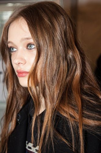 <p><strong>The look:</strong> James Pecis for Moroccanoil created luxurious, natural looking, wavy hair with soft, off-centre partings. "The hair is rich and beautiful" he said. Makeup artist Tom Pecheux said the look is "cool London girl". Take that Milan! "She has edges and is a bit rough." Oh. </p>
<p><strong>The products:</strong> Eyes: MAC Ebony Eye Pencil applied through lashline, waterline and around the eye. Hair: Moroccanoil Volumising Mousse.</p>