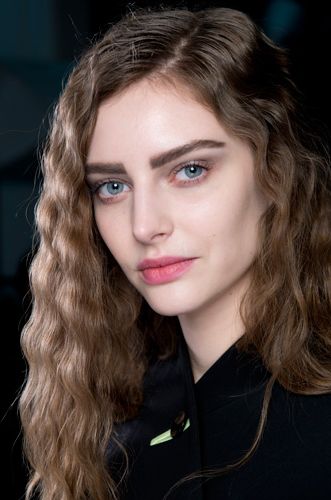 <p><strong>The look:</strong> Giorgio Armani's makeup artist Linda Cantello designed eyes with a wash of colour to "fade to grey", with straight graphic eyebrows and a berry mouth. Hair, parted low to one side, was given chunky crimps with a three-barrel waver. So yeah – crimped hair is back!</p>
<p><strong>The products:</strong> Brows: Eye&Brow Maestro in one or two shades darker than the natural colour. Eyes: Fall Collection Eyes To Kill liquid eyeliner shade 3 Mercury Nude (out August 2014). Eyes To Kill Mascara on top lashes Lips: Rouge Ecstasy shade 602 Night Viper dabbed on. All Giorgio Armani.</p>