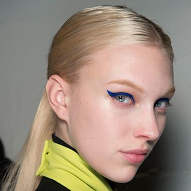 <p><strong>The look:</strong> Makeup artist Aaron de Mey used MAC to give girls 50s inspired sharp flicks in bright blue. Hair was flatly centre-parted and positioned into ponies between the middle of the head and the nape of the neck.</p>
<p><strong>The products:</strong> Eyes: MAC PRO Marine Ultra Chromaline drawn through the upper lashline and over the lid.</p>