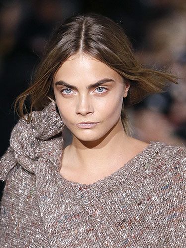 <p><strong>The look:</strong> Eugene Souleiman gave models including Cara Delevingne (pictured) loose, textured ponytails with centre partings. Makeup by Pat McGrath MBE was barely there – merely defined eyes and balmy lips.</p>