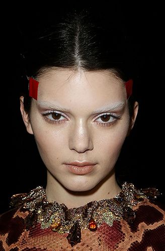 <p><strong>The look:</strong> Models including Kendall Jenner (pictured) had their brows bleached by the legendary Pat McGrath who then contoured the skin in varying neutral shades. To get a feline shape with their eyes, hairstylist Luigi Murenu tightly taped string from the temples around the back of the head and created knotted plaits below.</p>