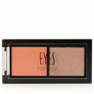 <p>We go to great lengths to ensure fake tan never turns our skin orange, but pop the shade on eyes and it has a brightening effect. Which why we've fallen for this eye duo from the beauty brains at Topshop, who seem to have their finger on the pulse of the biggest makeup trends.<br /><br />This duo is night eyes in one palette and looks great against blue tones, simply prime your lids and sweep on the orange right up to the eye socket. If you want more definition, work the dark shade through the crease, or create a pretty, rose gold effect by sweeping over the orange shade. Dreamy.</p>
<p><a href="http://www.topshop.com/webapp/wcs/stores/servlet/ProductDisplay?beginIndex=0&viewAllFlag=&catalogId=33057&storeId=12556&productId=14219063&langId=-1&categoryId=&parent_category_rn=&searchTerm=TS20T02FCOR&resultCount=1&geoip=home" target="_blank">Topshop Long Weekend Eye Duo, £6</a></p>