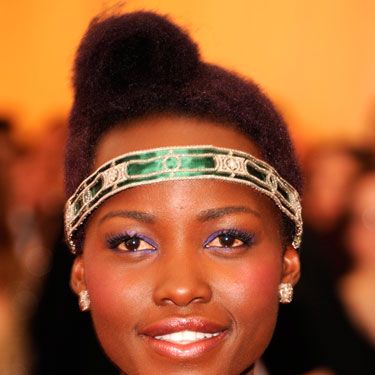 Lupita didn’t disappoint with her emerald flapper girl headband and amethyst eye makeup. The retro pompadour roll, styled to the side, was equally artistic.<p><a href="http://www.cosmopolitan.co.uk/fashion/news/kendall-jenner-wears-topshop-to-met-ball-gala" target="_blank">KENDALL JENNER WEARS TOPSHOP AT THE MET BALL</a></p>
<p><a href="http://www.cosmopolitan.co.uk/fashion/news/met-gala-2014-red-carpet-dresses" target="_blank">THE FULL MET BALL 2014 RED CARPET</a></p>
<p><a href="http://www.cosmopolitan.co.uk/celebs/celebrity-gossip/10-favourite-met-ball-instagrams" target="_blank">BEHIND THE SCENES OF THE MET BALL IN CELEBRITY INSTAGRAMS</a></p>