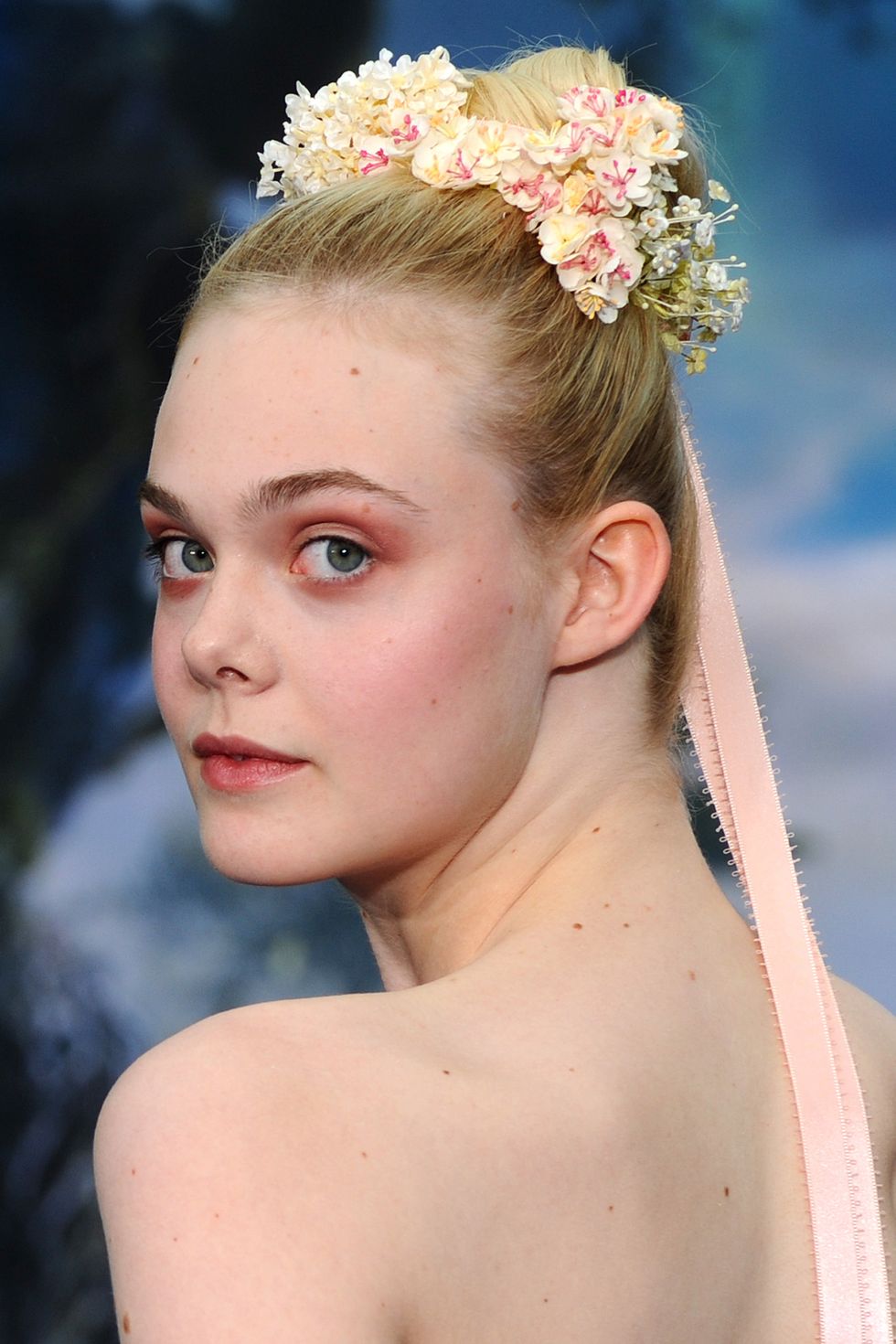 <p>It's only fitting Elle Fanning wore this look to promote Maleficent; the floral crown looping around her bun is a true fairytale look. And while we don't expect you to adorn yourself in ribbons like a Maypole, adding flowers to a tight topknot makes a great festival 'do.</p>
<p><a href="http://www.cosmopolitan.co.uk/beauty-hair/beauty-tips/wedding-hair-inspiration-how-to-choose-hair-accessory?click=main_sr" target="_blank">HOW TO CHOOSE A WEDDING HAIR ACCESSORY</a></p>
<p><a href="http://www.cosmopolitan.co.uk/beauty-hair/news/styles/hair-trends-spring-summer-2014?click=main_sr" target="_blank">THE HUGE HAIR TRENDS FOR 2014</a></p>
<p><a href="http://www.cosmopolitan.co.uk/beauty-hair/news/beauty-news/how-to-do-festival-plait-hairstyle?click=main_sr" target="_blank">HAIR HOW-TO: FESTIVAL PLAITS</a></p>