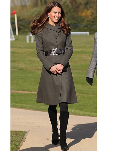 <p>What does one wear to meet the England football squad? Well, something warm and comfy if you're Kate Middleton. KMiddy met the squad in an olive green belted coat from Reiss and her trusty black knee-high boots. What, no nude heels?! Oh well, she still scored with us!</p>