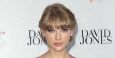 Taylor Swift busts out in a cleavage-bearing gown