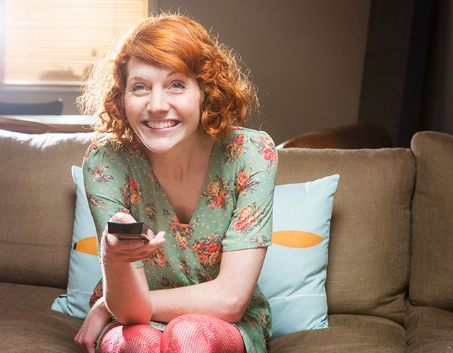 Smile, Comfort, Sitting, Living room, Couch, Furniture, Red hair, Jewellery, Lap, Tooth, 
