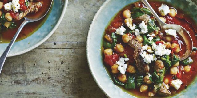 Harissa lamb and chickpea soup in two bowls with spoons