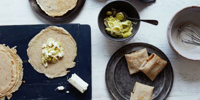 Leek and goat's cheese crepes on pans and boards