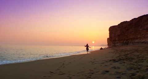 Woman on beach at sunset