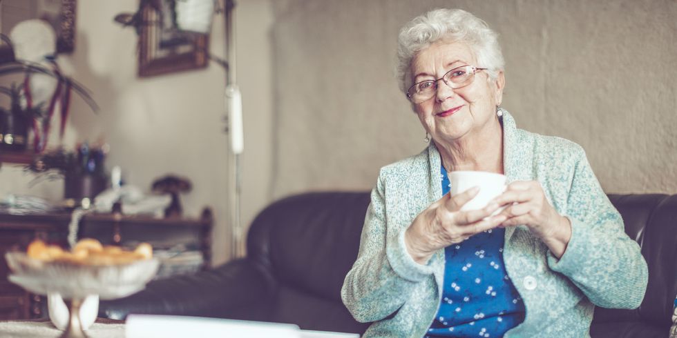 Smiling older woman with hot drink