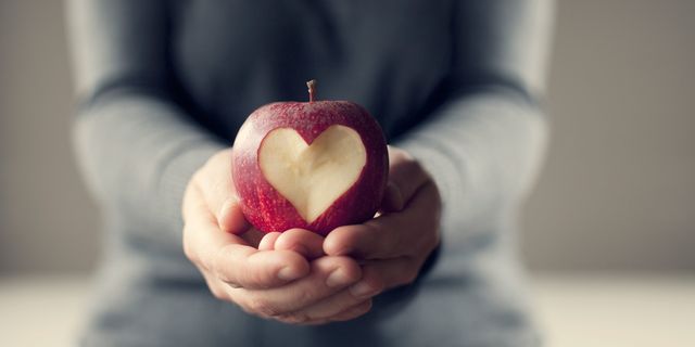 Hands holding heart apple