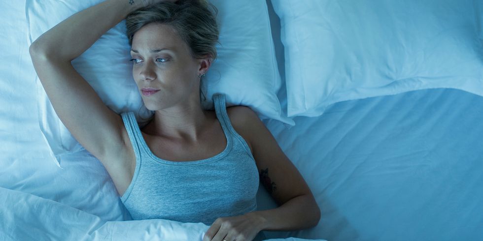 Woman awake in bed can't sleep