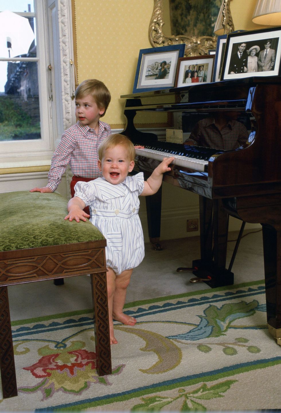 <p>Harry, 11 months, plays with the piano with his brother William, three, at their home in Kensington Palace.</p>
