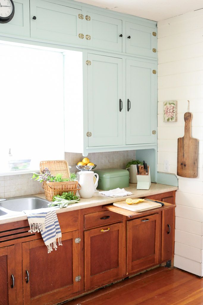 https://hips.hearstapps.com/countryliving/assets/17/18/1493756999-farmhouse-kitchen-mint-upper-cabinets-wood-lowers-mamas-dance-2.jpg
