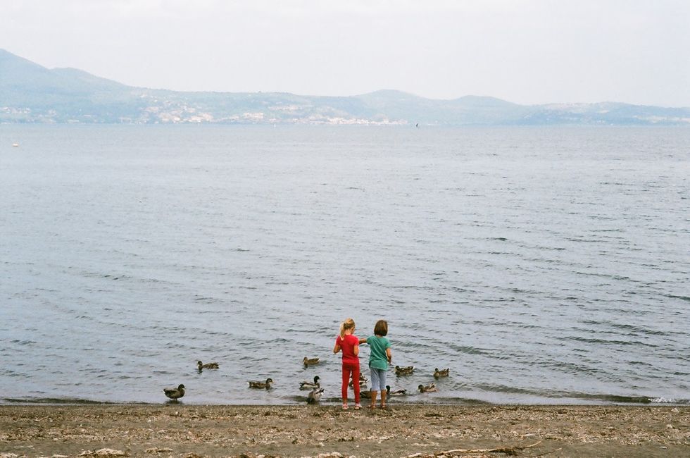 Body of water, Coastal and oceanic landforms, Human, Shore, Coast, Beach, Sea, People in nature, Mountain range, Atmospheric phenomenon, 