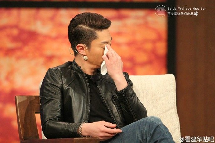 Ear, Hairstyle, Jacket, Sitting, Earrings, Black hair, Leather jacket, Couch, Long hair, Hearing, 