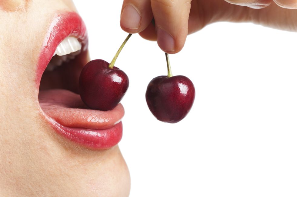 Skin, Cherry, Natural foods, Lip, Fruit, Mouth, Finger, Hand, Close-up, Nose, 