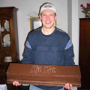 Cap, Ear, Wood, Facial expression, Baseball cap, Organ, Headgear, Wood stain, Varnish, Laugh, 