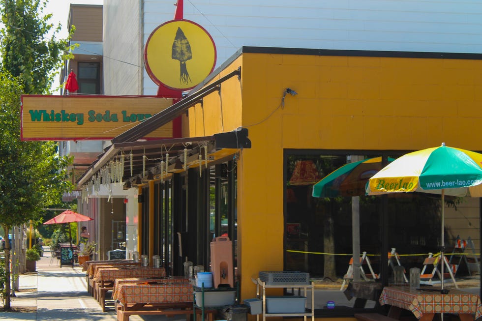 Outdoor furniture, Signage, Umbrella, Shade, Bench, Sign, Outdoor table, Awning, Restaurant, 