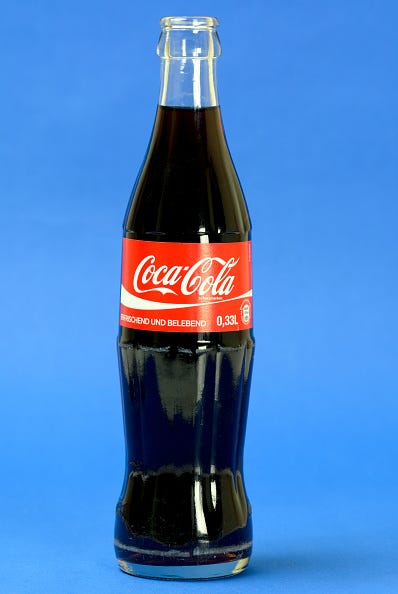 Liquid, Glass, Bottle, Drink, Red, Cola, Carbonated soft drinks, Drinkware, Glass bottle, Flowering plant, 