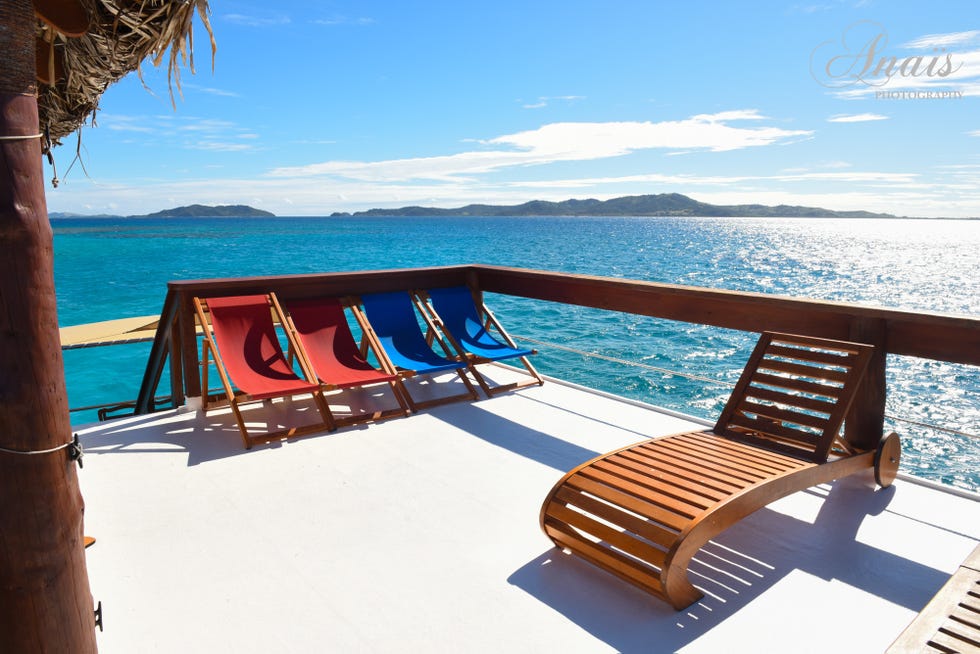 Coastal and oceanic landforms, Ocean, Outdoor furniture, Sunlounger, Resort, Horizon, Sea, Azure, Beach, Tropics, 