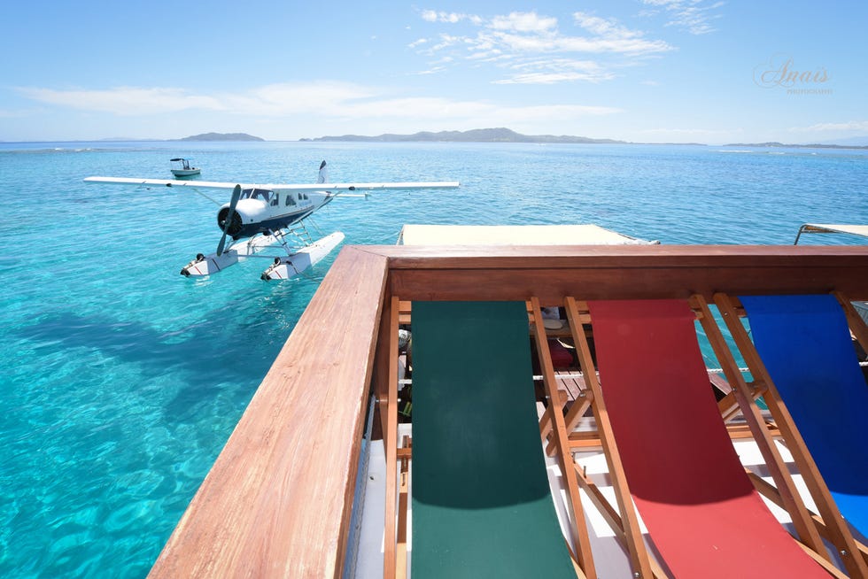 Body of water, Airplane, Water, Aircraft, Seaplane, Ocean, Aqua, Propeller-driven aircraft, Coastal and oceanic landforms, Teal, 