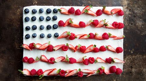 flag cake topped with whipped cream and berries