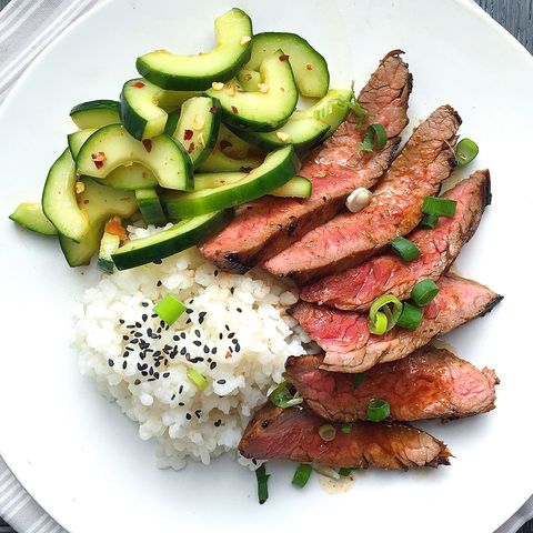 korean style grilled flank steak with sticky rice and spicy cucumber salad