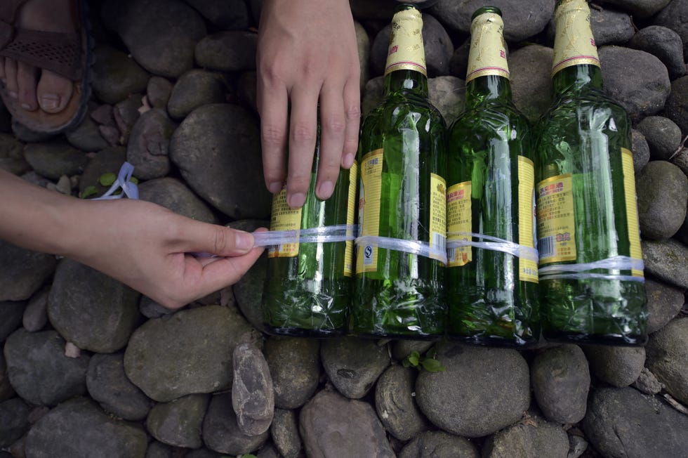 Finger, Bottle, Glass bottle, Rock, Alcohol, Drink, Drinkware, Pebble, Thumb, Nail, 