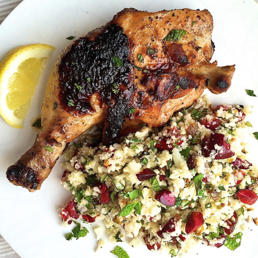 spicy chicken legs and cauliflower couscous with cherries, pistachios, and mint