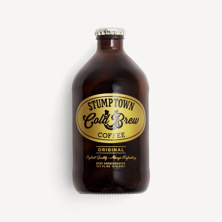 Brown, Bottle, Liquid, Bottle cap, Alcohol, Alcoholic beverage, Glass bottle, Logo, Font, Black, 