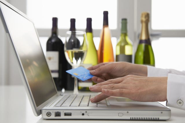 Bottle, Wine bottle, Product, Alcohol, Laptop, Technology, Electronic device, Wine, Finger, Drinkware, 