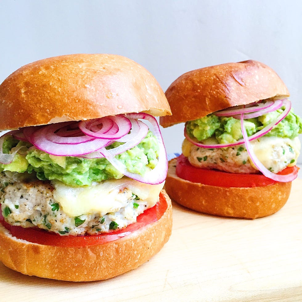 spicy chicken burgers with guacamole, cheddar, and pickled onions