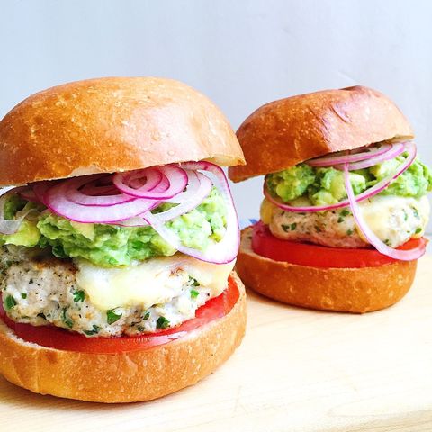 spicy chicken burgers with guacamole, cheddar, and pickled onions