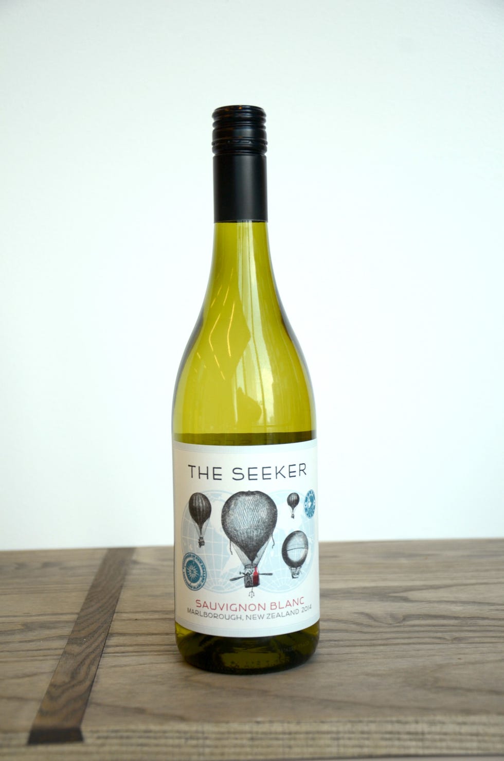 Product, Wood, Glass bottle, Yellow, Bottle, Drink, Liquid, Alcoholic beverage, Logo, Hardwood, 