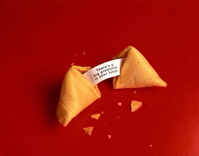 Red, Food, Paper product, Fortune cookie, Carmine, Paper, Cuisine, Sweetness, Cone, Triangle, 