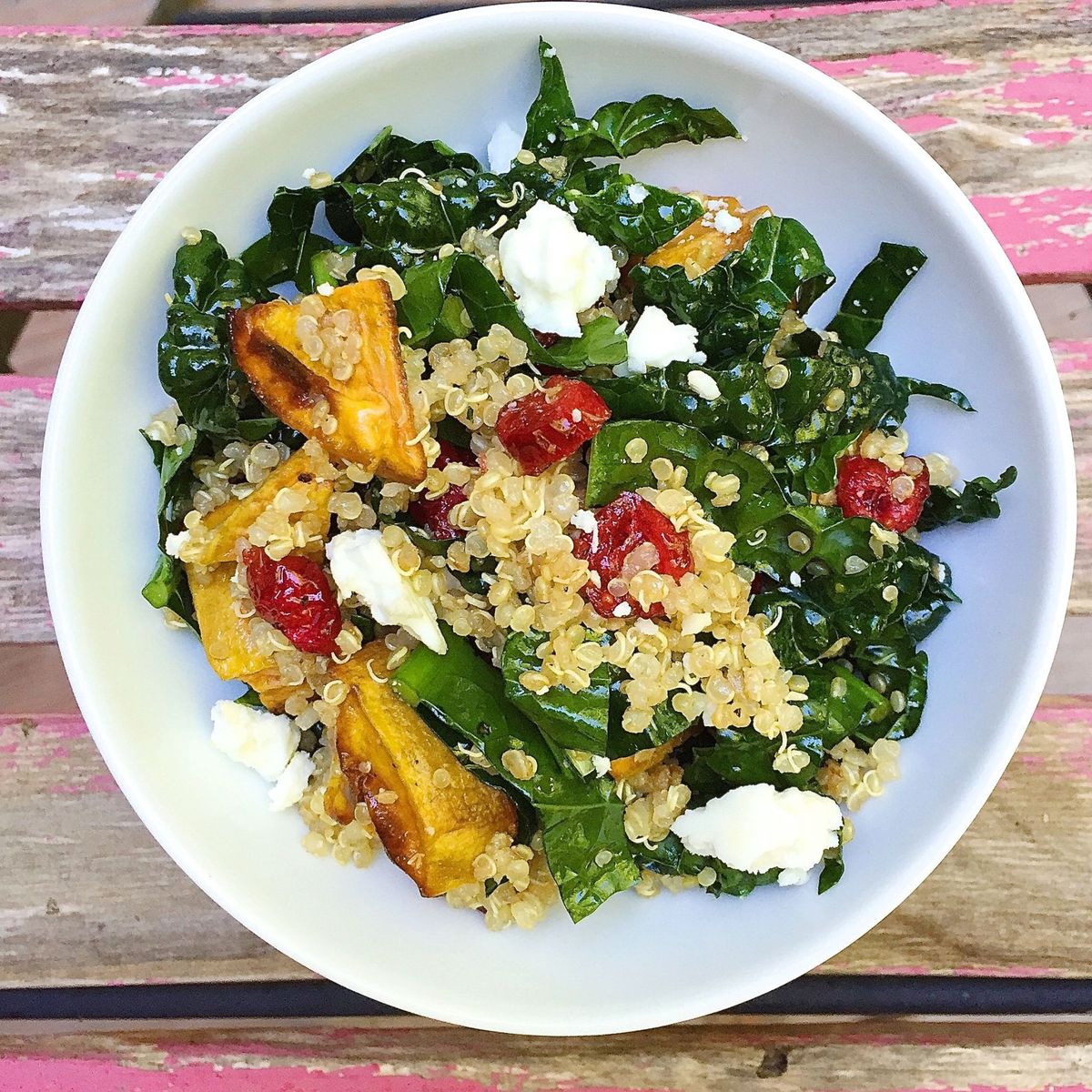roasted sweet potatoes with quinoa, kale, dried cranberries, and feta