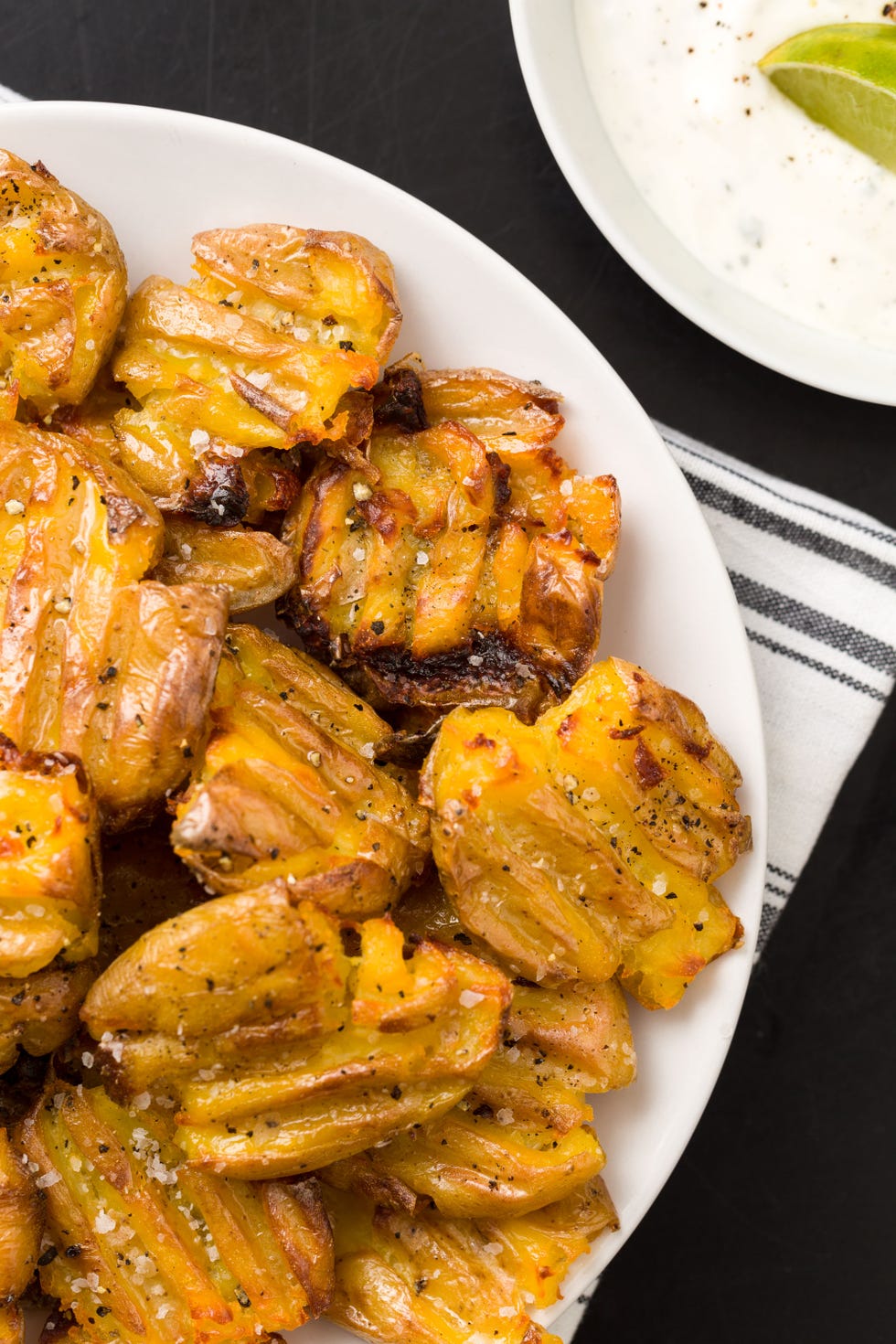 <p>Potatoes on a party spread don't have to mean fries. These easy smashed spuds have a killer ranch-laced dipping sauce no one will be able to pass up.</p><p>Get the recipe on <a target="_blank" href="http://gogonow.org/entertaining/tabletop/recipes/a44515/smashed-potatoes-with-ranch-lime-crema-recipe/%22%3EDelish%3C/a%3E.%3Cbr%3E%3C/p%3E