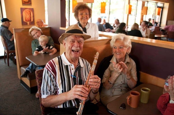 Smile, Serveware, Wind instrument, Hat, Woodwind instrument, Music artist, Musical instrument, Reed instrument, Sun hat, Clarinetist, 