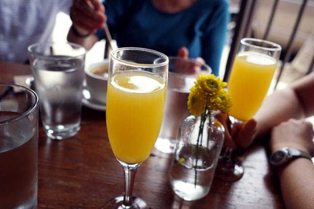 Yellow, Drink, Tableware, Barware, Glass, Watch, Juice, Drinkware, Table, Orange juice, 