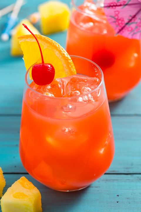 hurricane cocktail with cherry and orange wedge