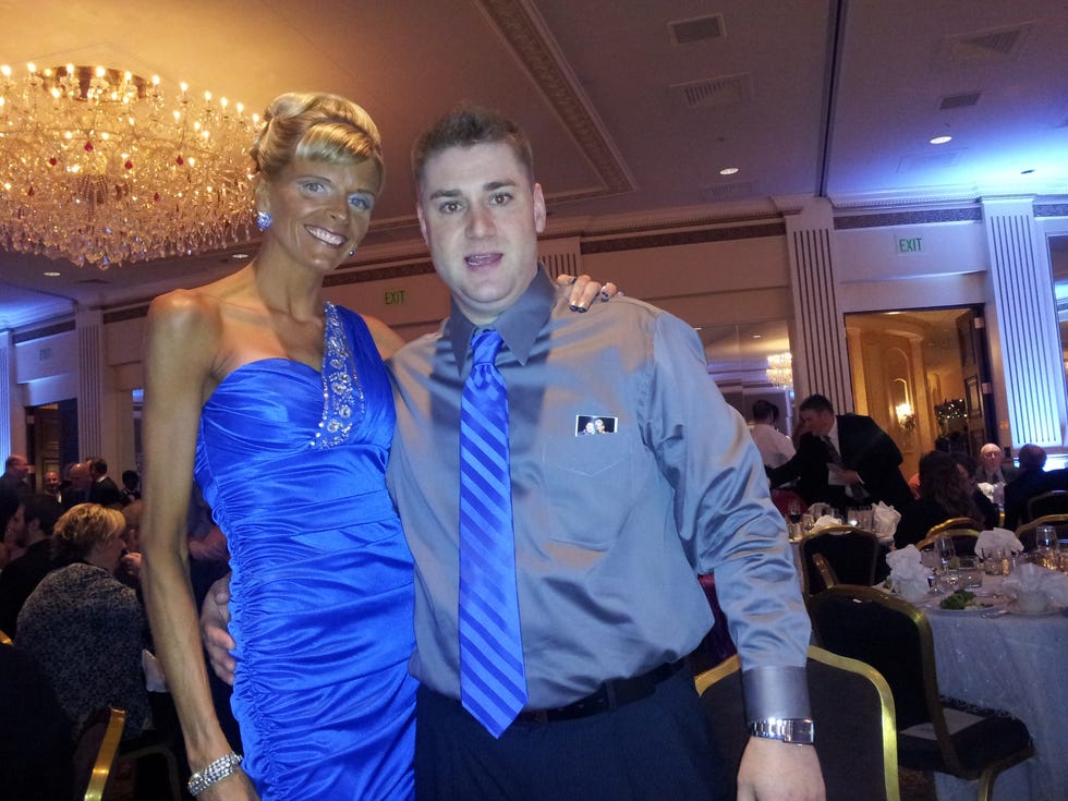 Arm, Lighting, Event, Dress, Chair, Function hall, Ceiling, Strapless dress, Cobalt blue, Tie, 