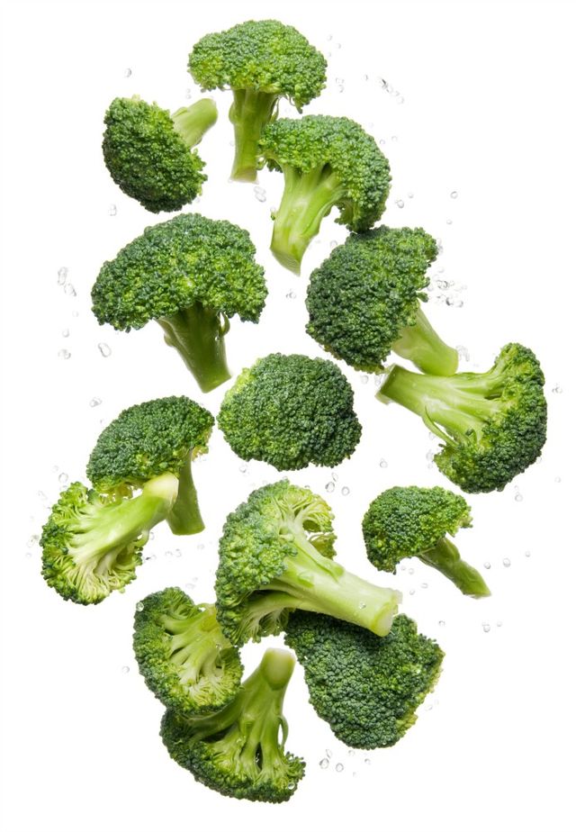 Healthy eating clean organic fresh vegetable Broccoli flying and bouncing up into the air in studio on a white background for wellness